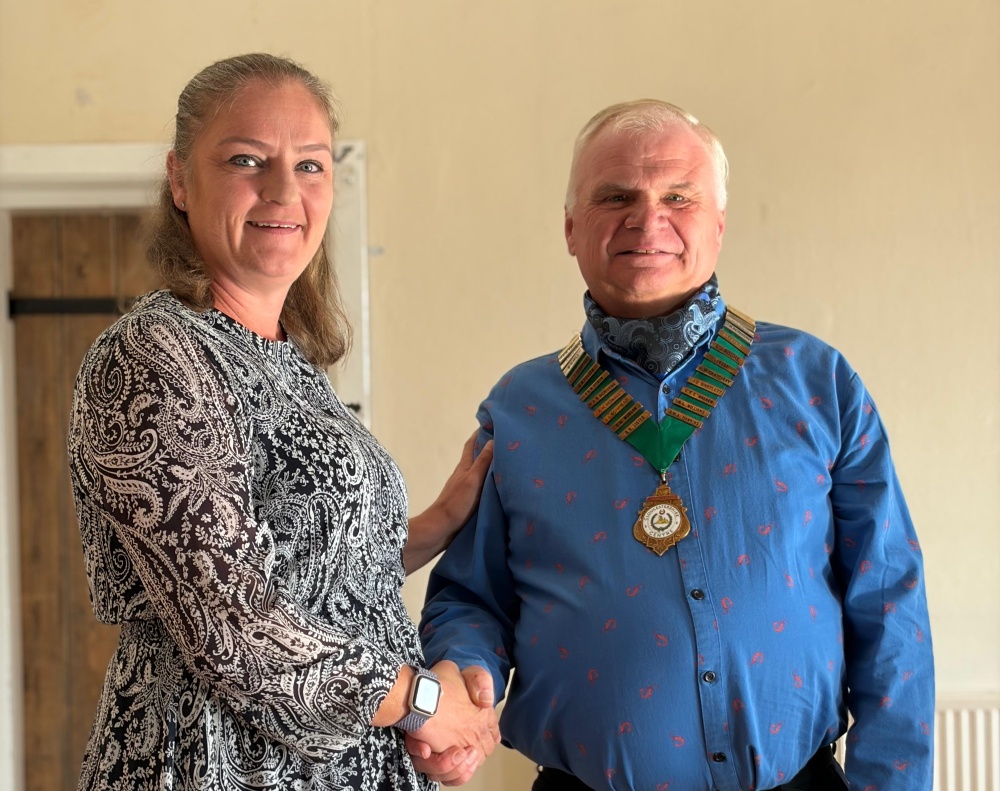 Donna-Marie Smith (left) announcing Mark Pillinger (right) as Chair at the 2026 AGM